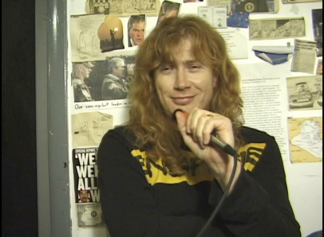 Dave Mustaine holding a microphone during the Rocks Vault interview.