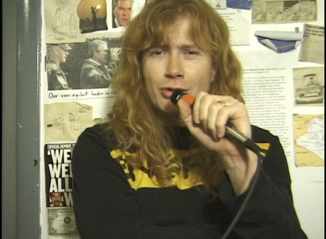 Dave Mustaine speaking into a microphone during the Rocks Vault interview.